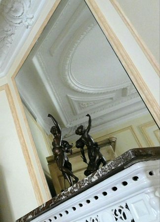 View of decor and ceiling in mirror above fireplace from bed view of decor and ceiling