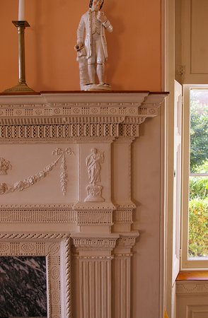 Intricate wood detailing at fireplace surround in parlor intricate wood detailing