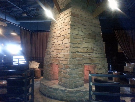 Wood burning fireplace in the center of the dining room at wood burning fireplace