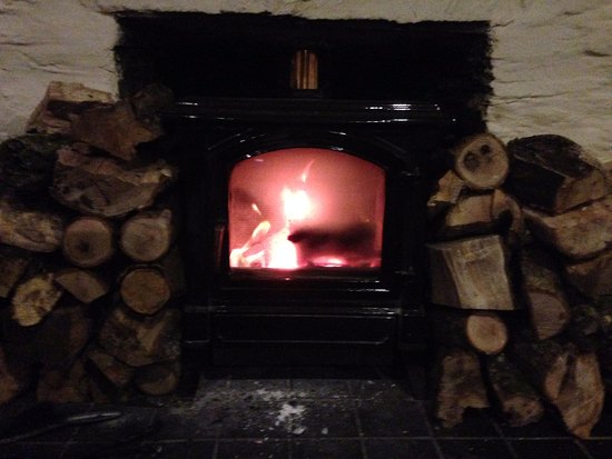 Lovely log burning fire in the restaurant Picture of wide lovely log burning fire