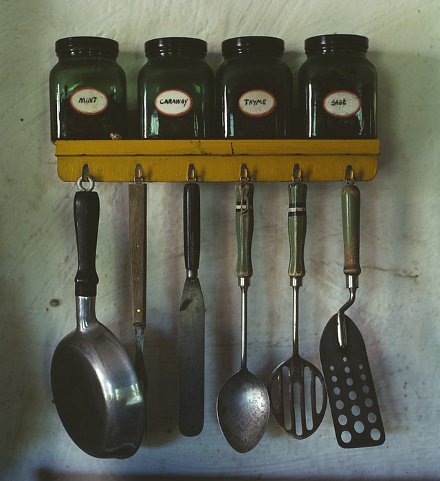 640px Kitchen utensils hanging below a spice rack