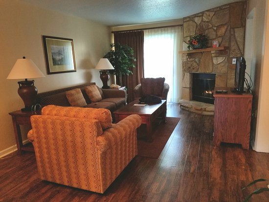 Poor photo of living room area with fireplace on right and poor photo of living