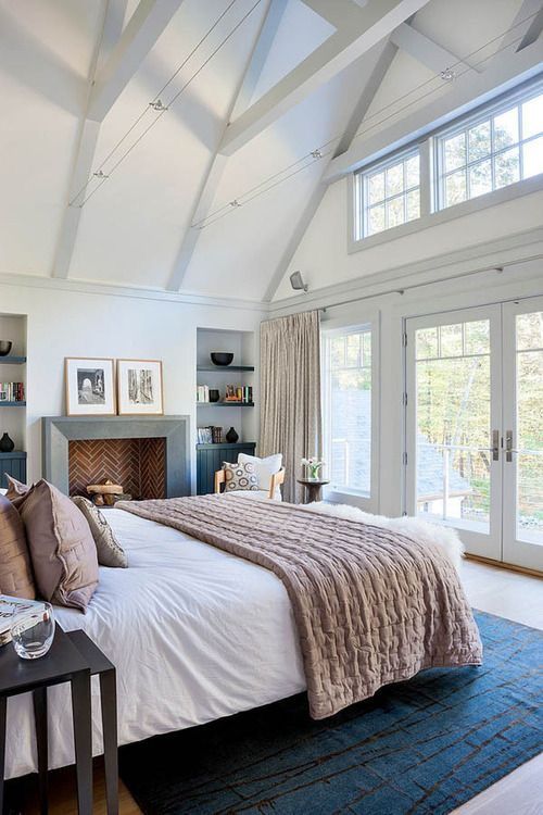 Master bedroom with fireplace and Lush throw and blue rug 0d347f af6db dc299c54