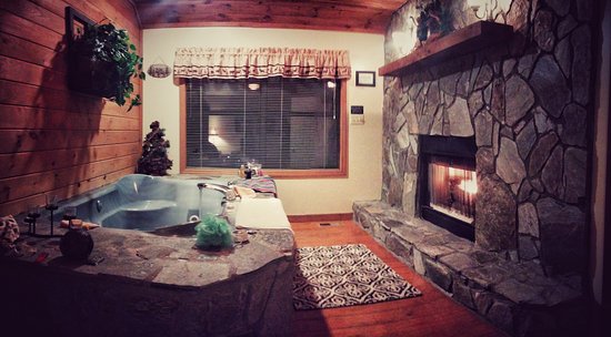 Romantic Getaways with Jacuzzi and Fireplace Elegant Jacuzzi Tub and Fireplace In Elsa Cabin View From Bed