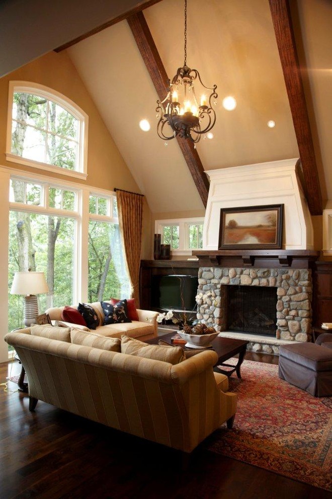 Stone fireplace mantel shelf living room traditional with ceiling lighting sloped ceiling window treatments 11