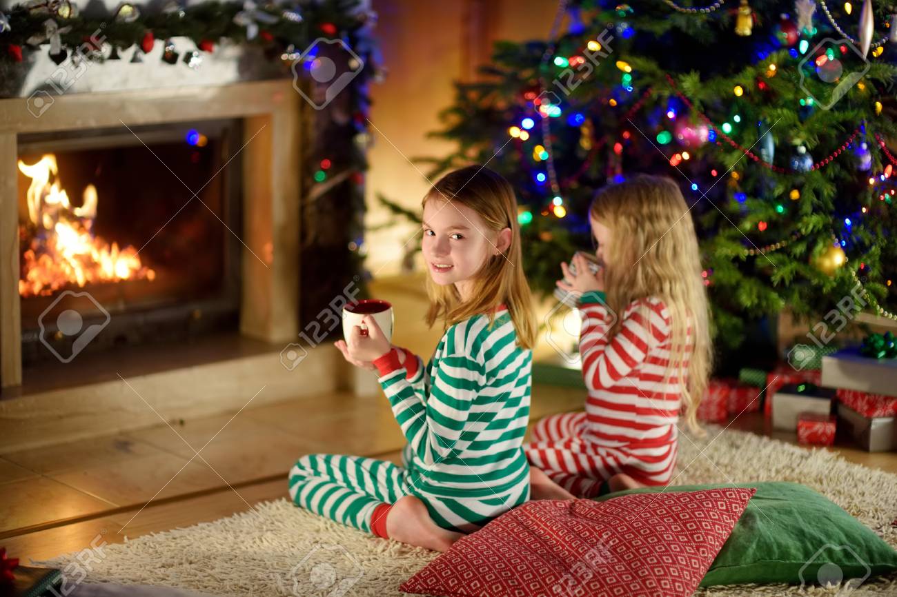 A Cozy Fireplace Luxury Two Cute Happy Girls Having Hot Chocolate by A Fireplace In A