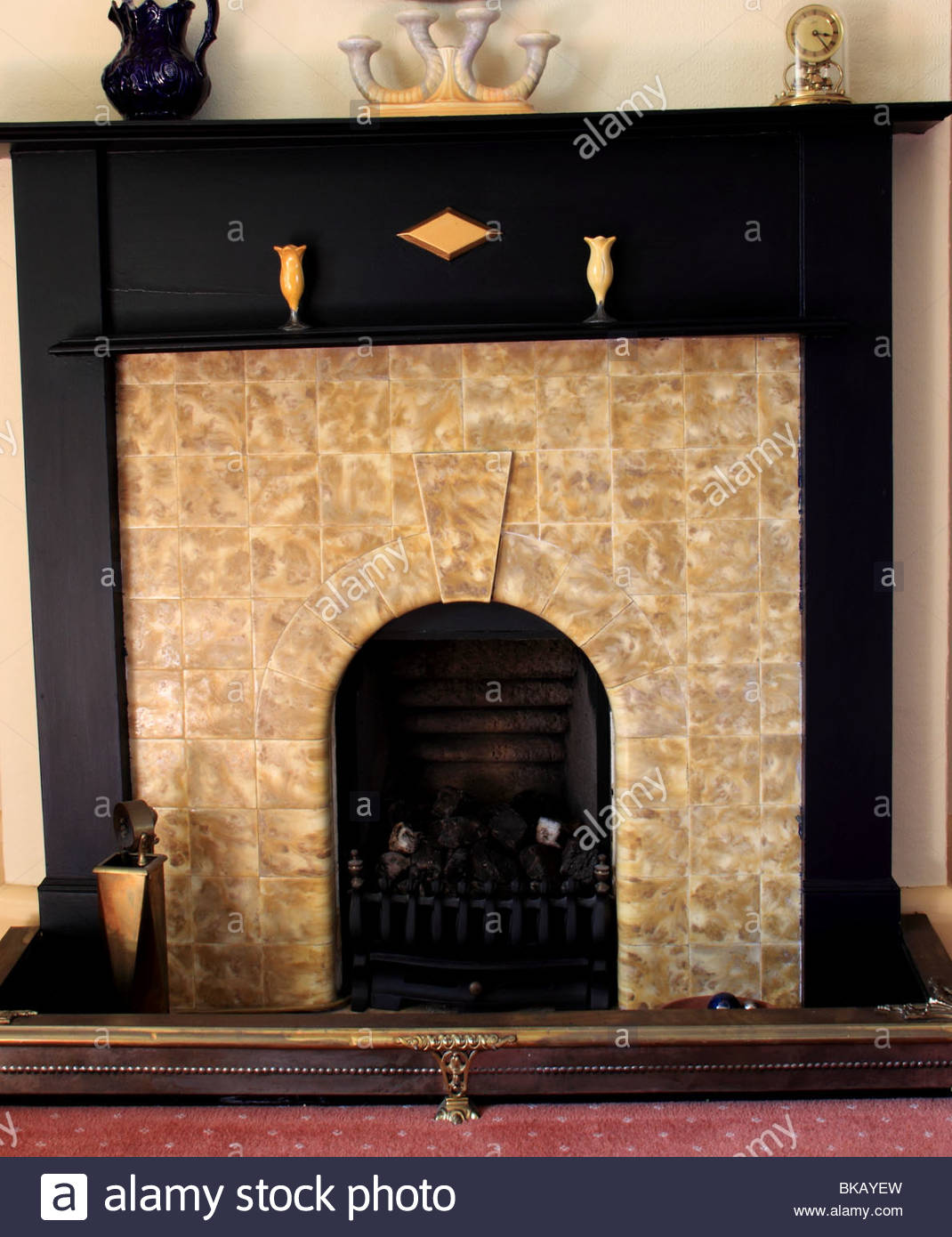 art deco fireplace with wooden surround and period ceramics BKAYEW