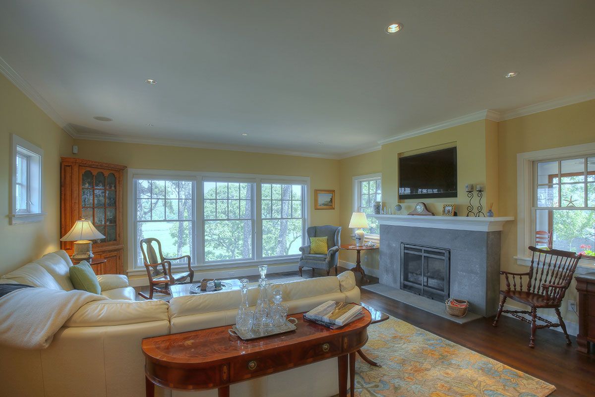 Cape Cod Fireplace Elegant Cape Cod Living Room with Beige Walls and Light Hardwood