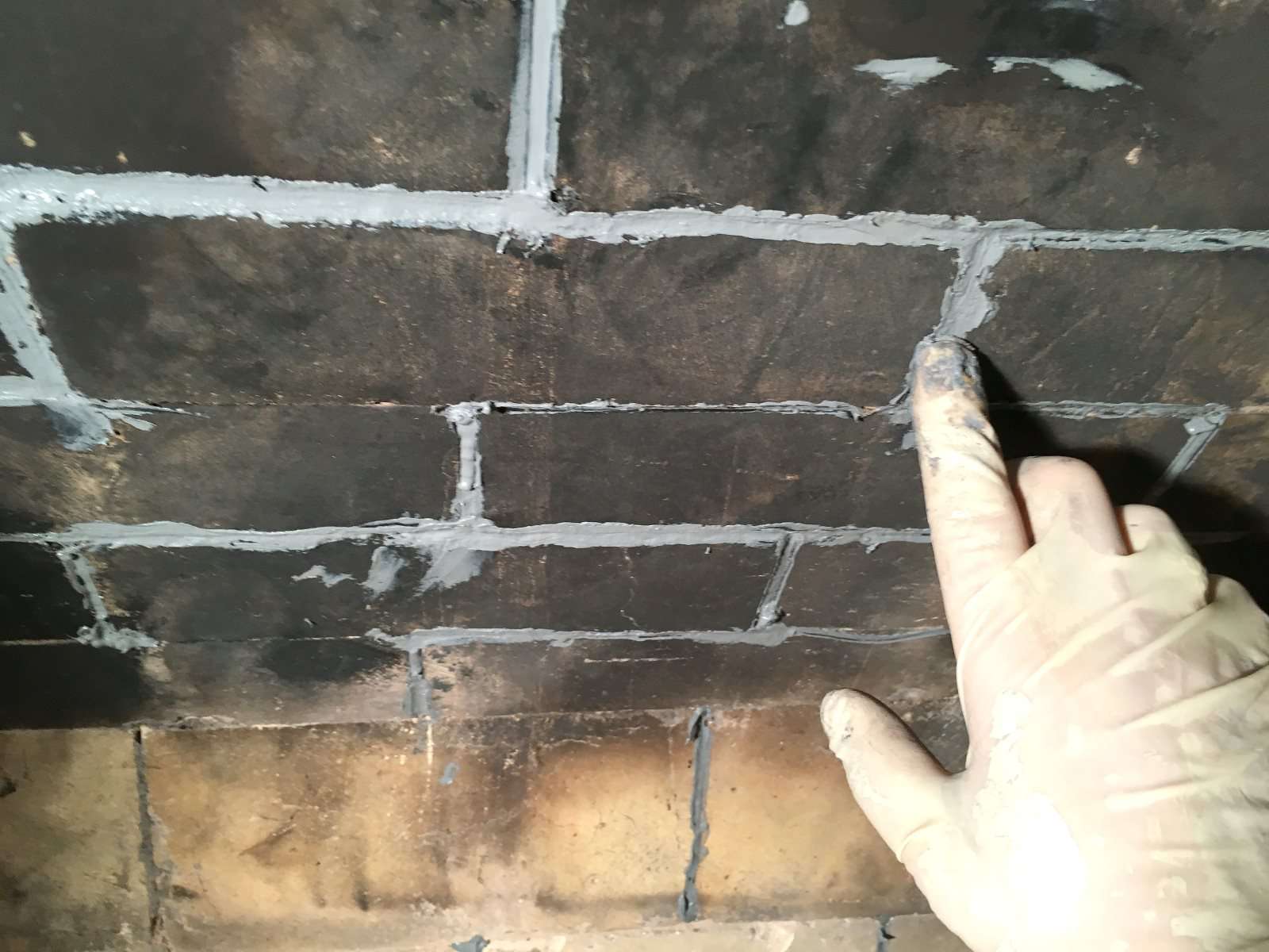 How to Fix Mortar Gaps in a Fireplace Fire Box 7 smooth caulk in fireplace joints 583c f9b58d5b12a7ce1 JPG