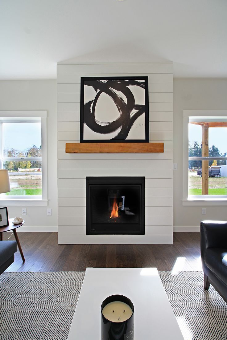 White shiplap fireplace surround with wood mantle dc93b29bd7c0f49c1412ac2ef0c