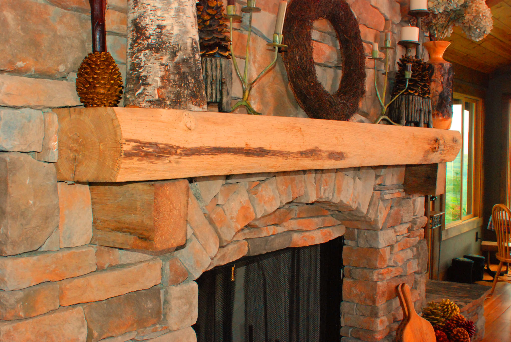 rustic live edge mantel corbels over stone fireplace in Black Mtn NC