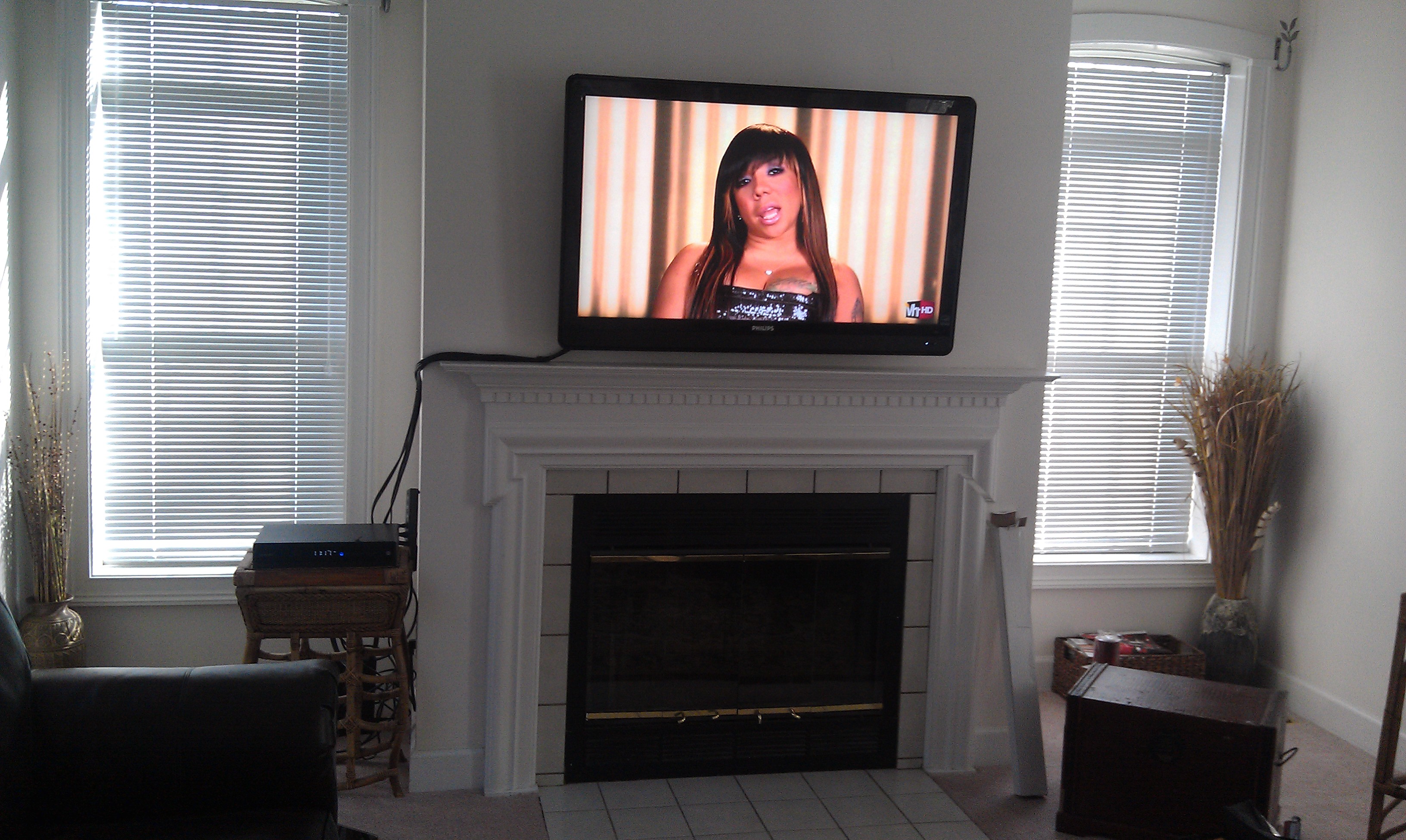 weathersfield ct tv mounted above fireplace with wires down the side 1