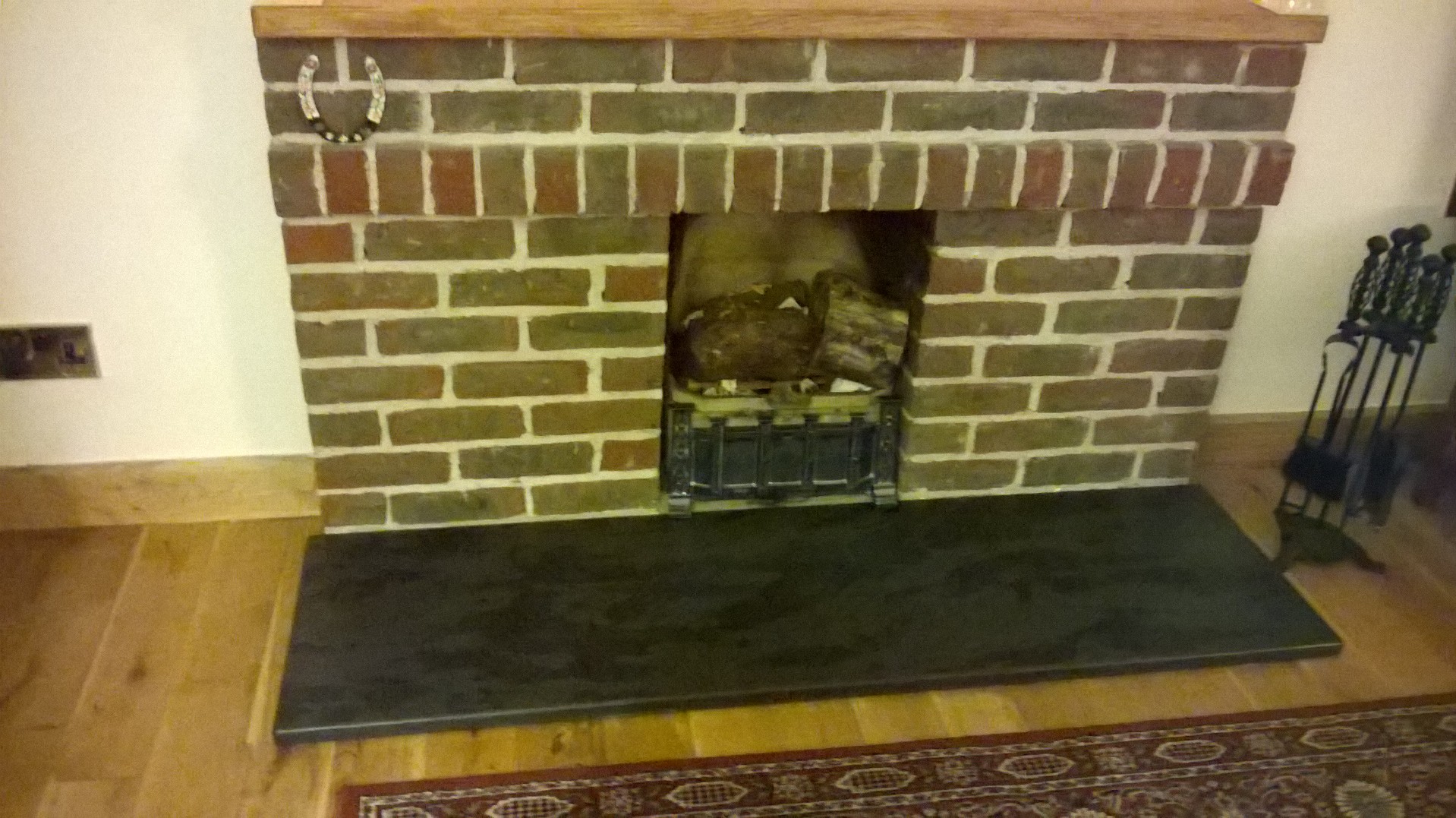 brick fireplace with black slate hearth
