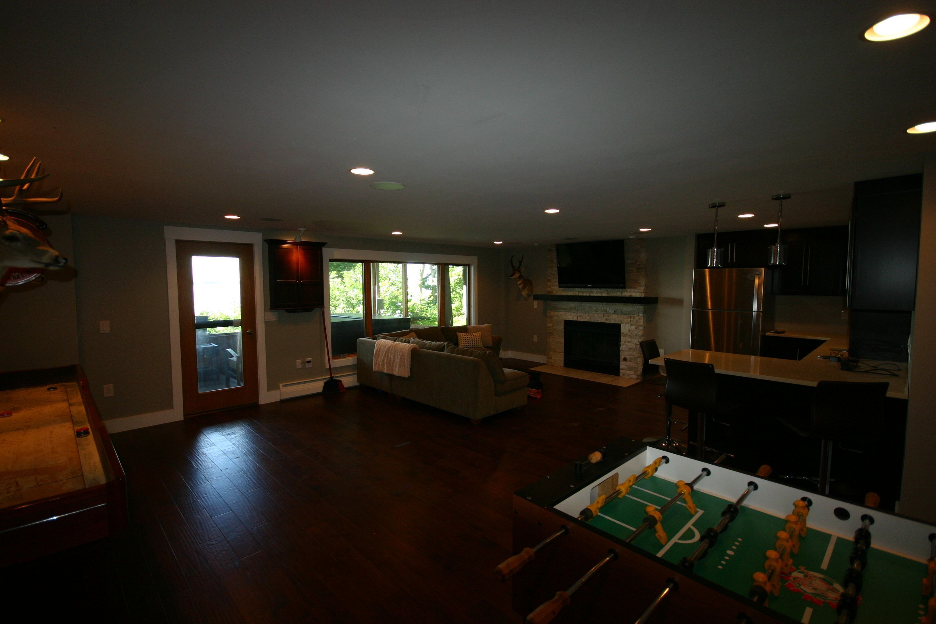 The Fireplace Man New Basement Man Cave Wood Flooring In A Basement Wet Bar