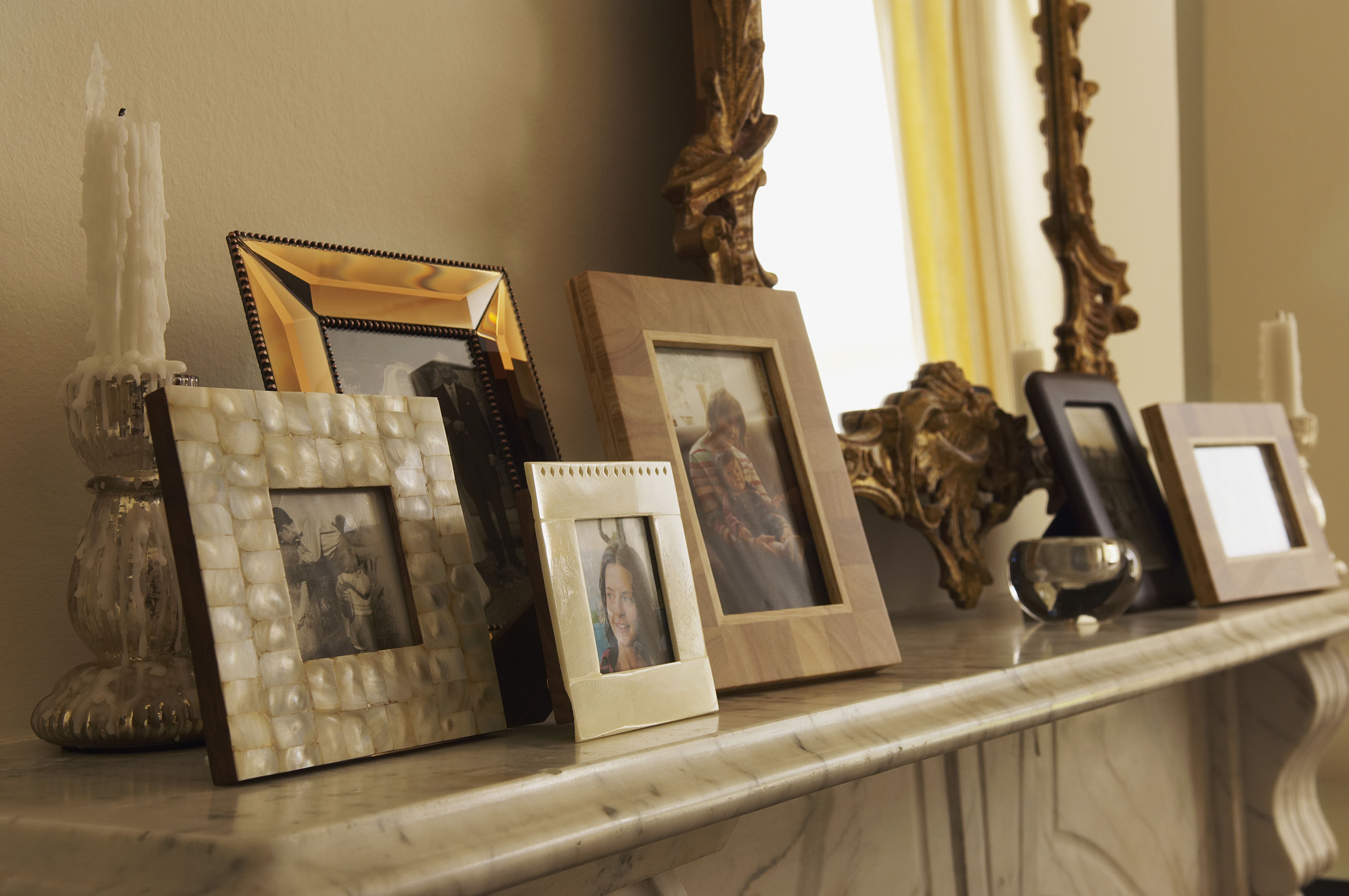 7 Styling Tips for an Elegant Mantel Display fireplace mantel with framed pictures 5a78fa9aba ce6