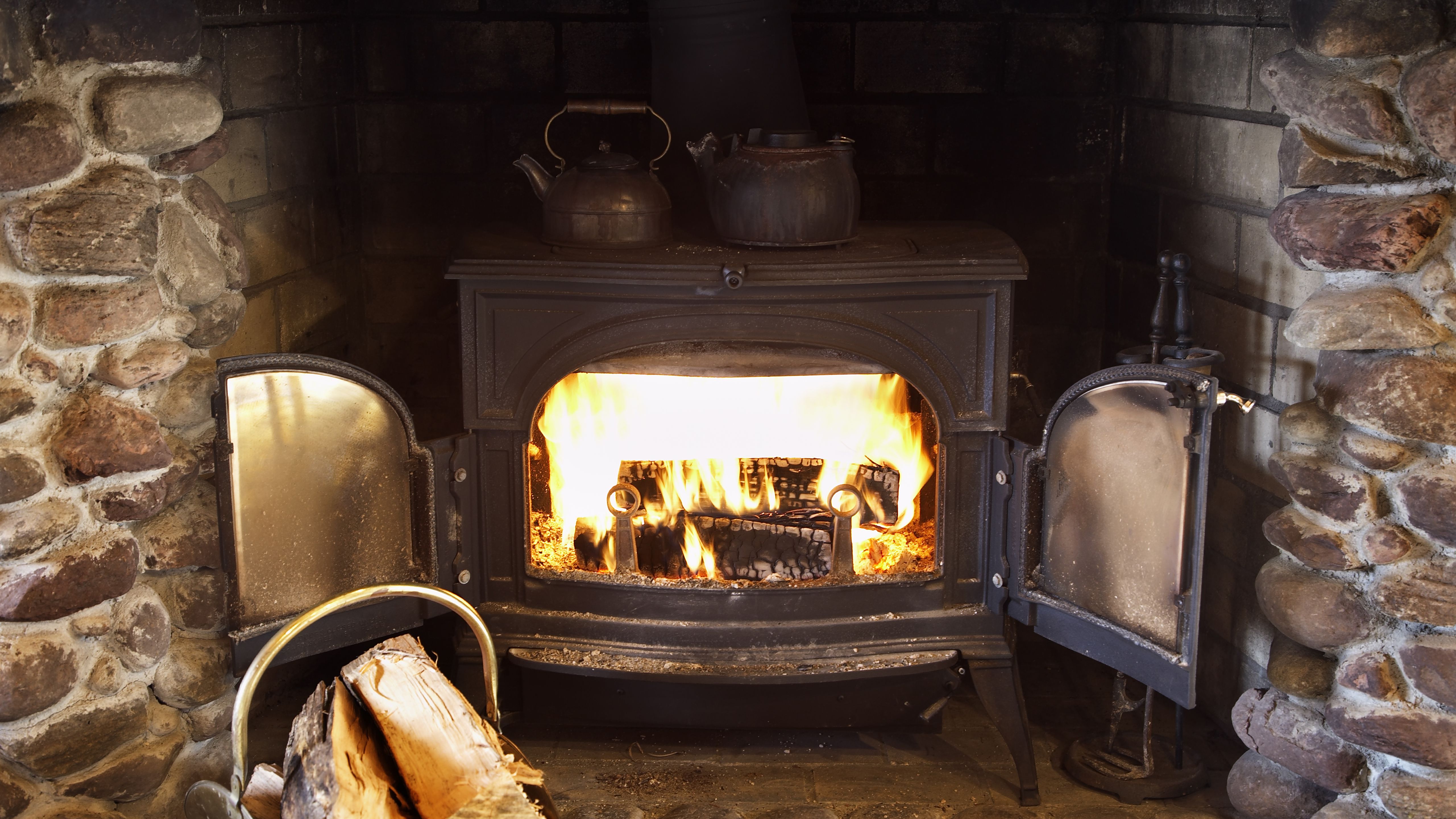 Wood Heat vs Pellet Stoves fire burning in wood stove 599e f53ba c76