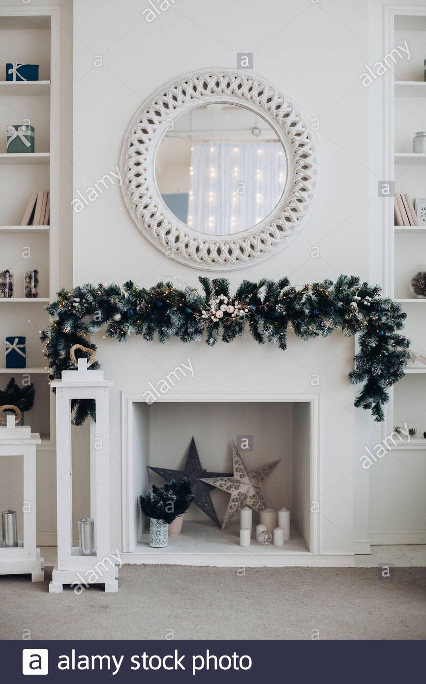 beautiful fireplace with mirror and fur branches 2AEB3G7