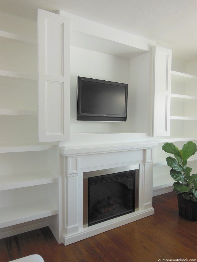 Built in TV nook over fireplace with bi fold doors to hide 752faaa44f0c60a1ab822b2a80c