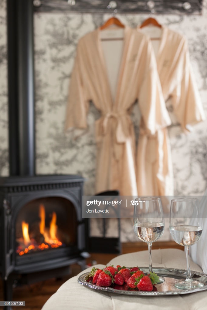 tray with wine and strawberries with robe and fireplace picture id