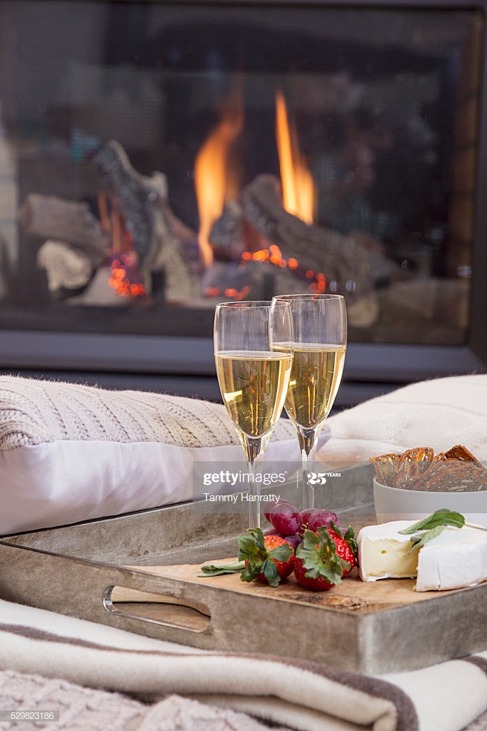 Tray With Champagne Flutes Sofa Fireplace In Background tray with champagne flutes on sofa fireplace in background picture id
